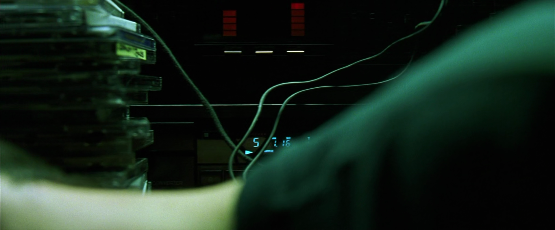 A screen capture from the movie The Matrix. In the scene where Neo is asleep at his desk, there is a slow pan of the camera just above his neck, where you can see the CD player and VU meter dimly, and can make out the track and position on the CD player, and two faint VU meters dancing along with the music.
